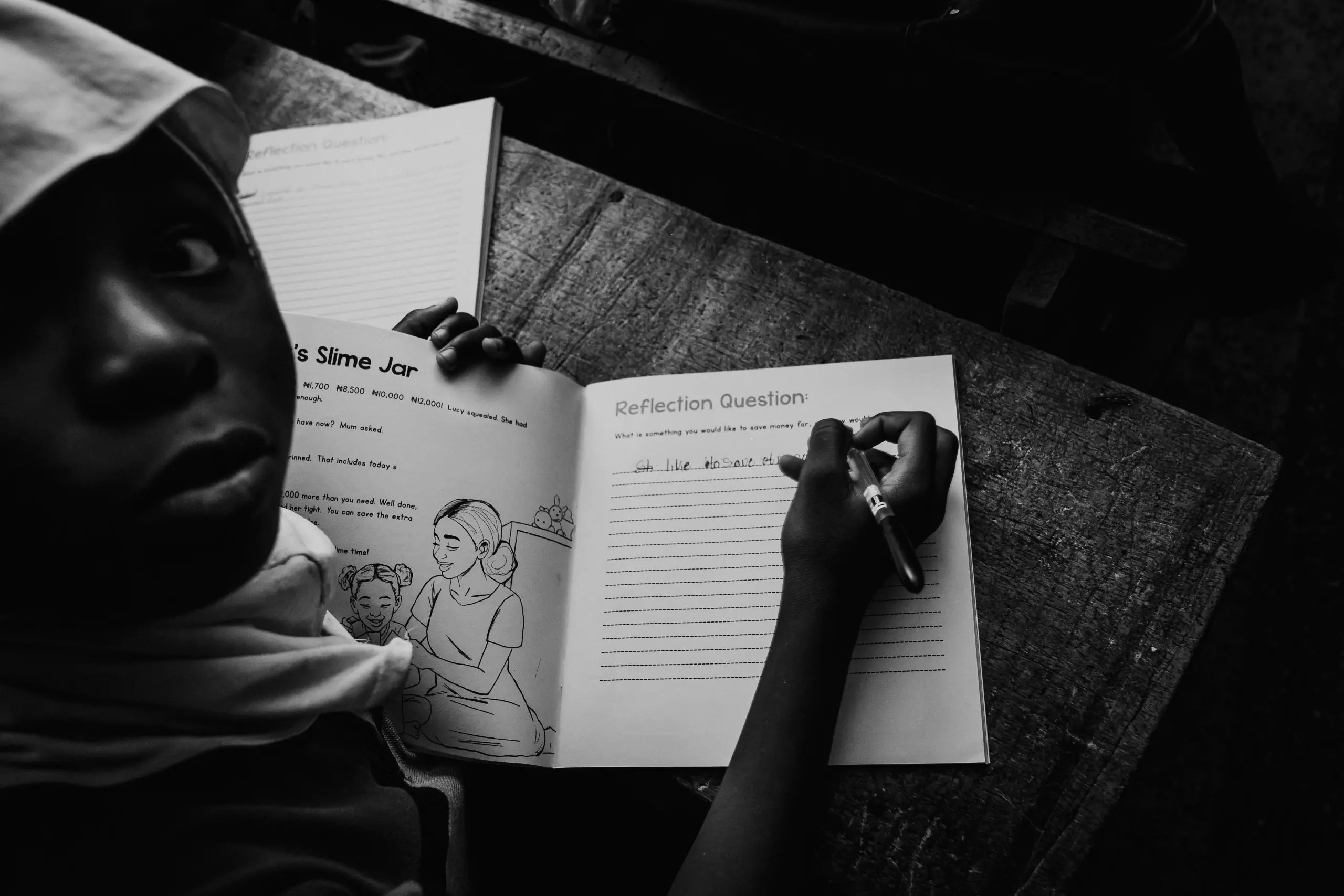 A pupil completing an exercise in the Little Heroes journal